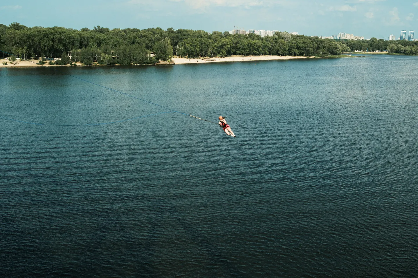 A person hangs from ropes above the Dnipro.