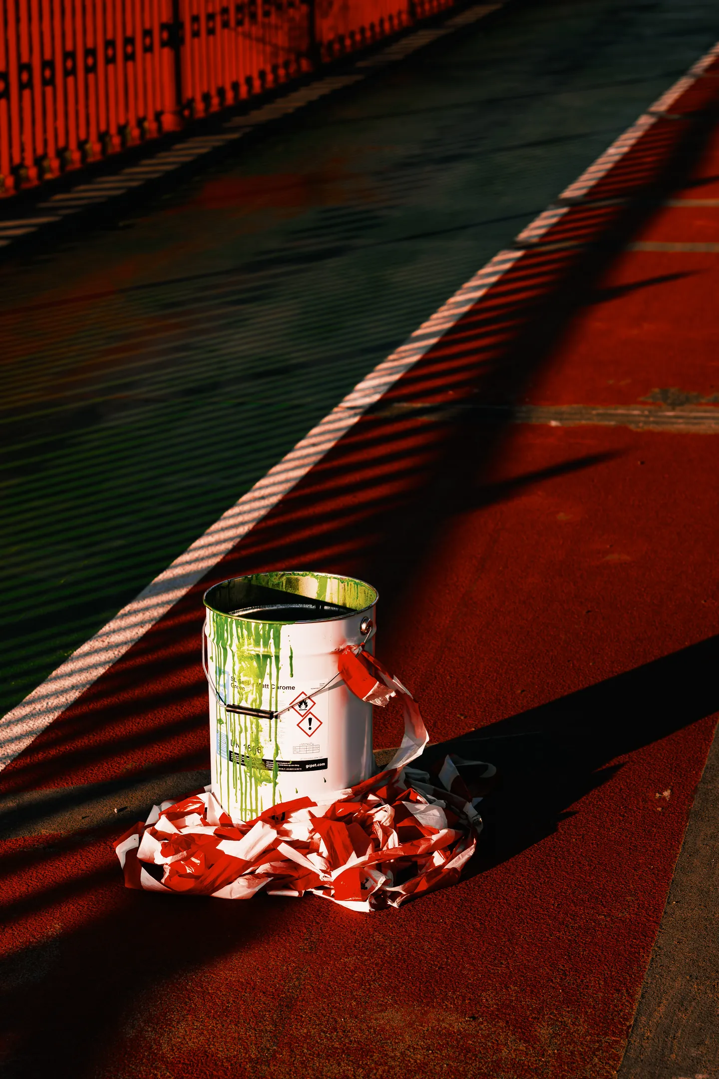 A paint can and barrier tape mark work on the cycle lane.