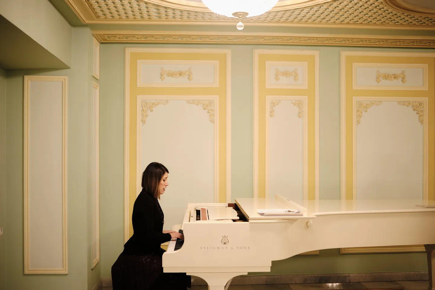 Pianist at a white grand piano