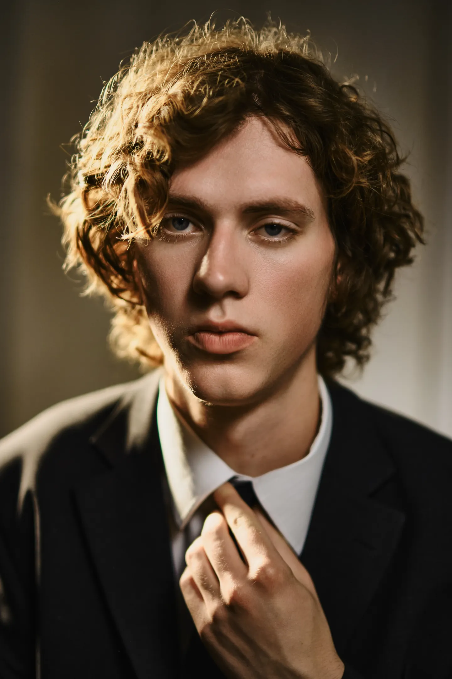 Portrait in a suit, lit from behind