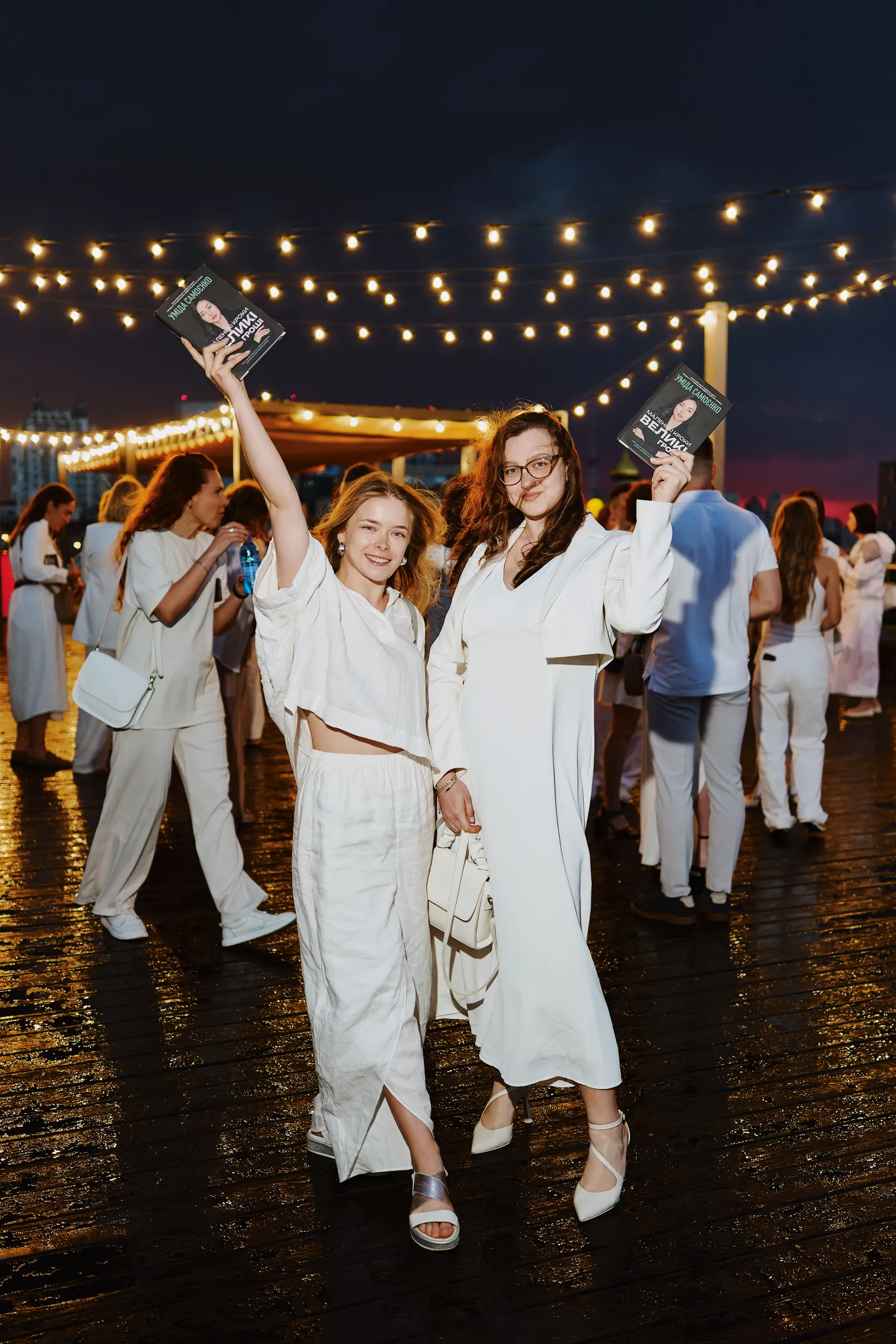 People dancing under string lights