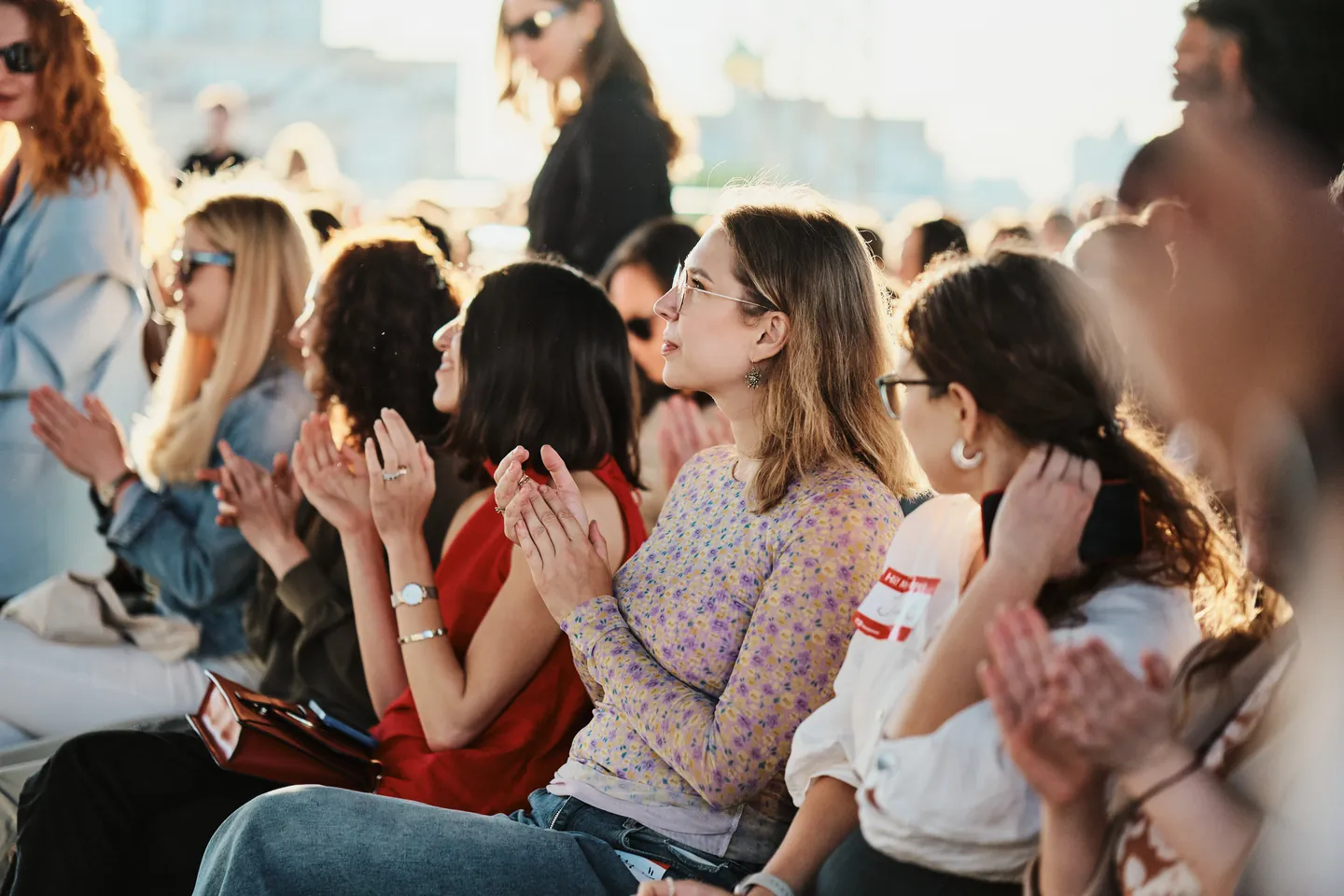 Audience applauding at an outdoor event